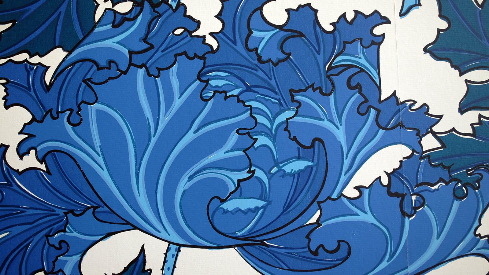 A white wallpaper with blue flowers over it.