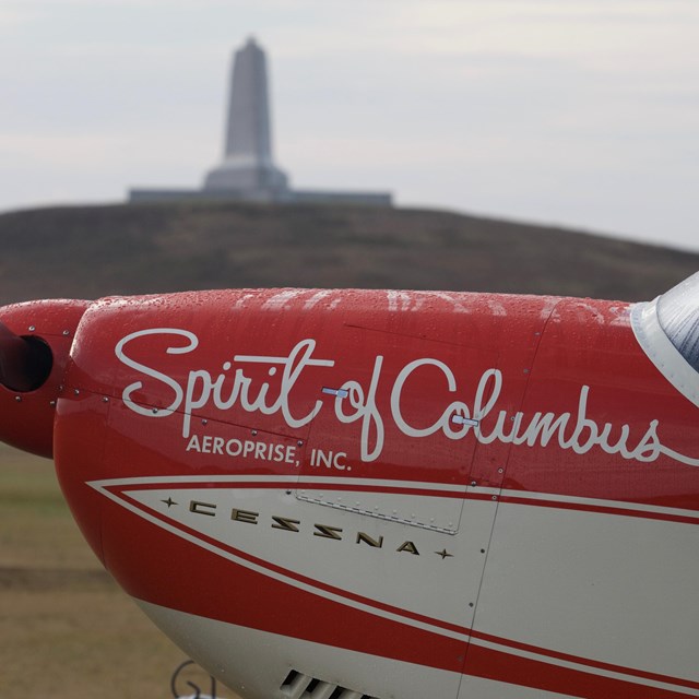 Civilian aircraft in front of monument