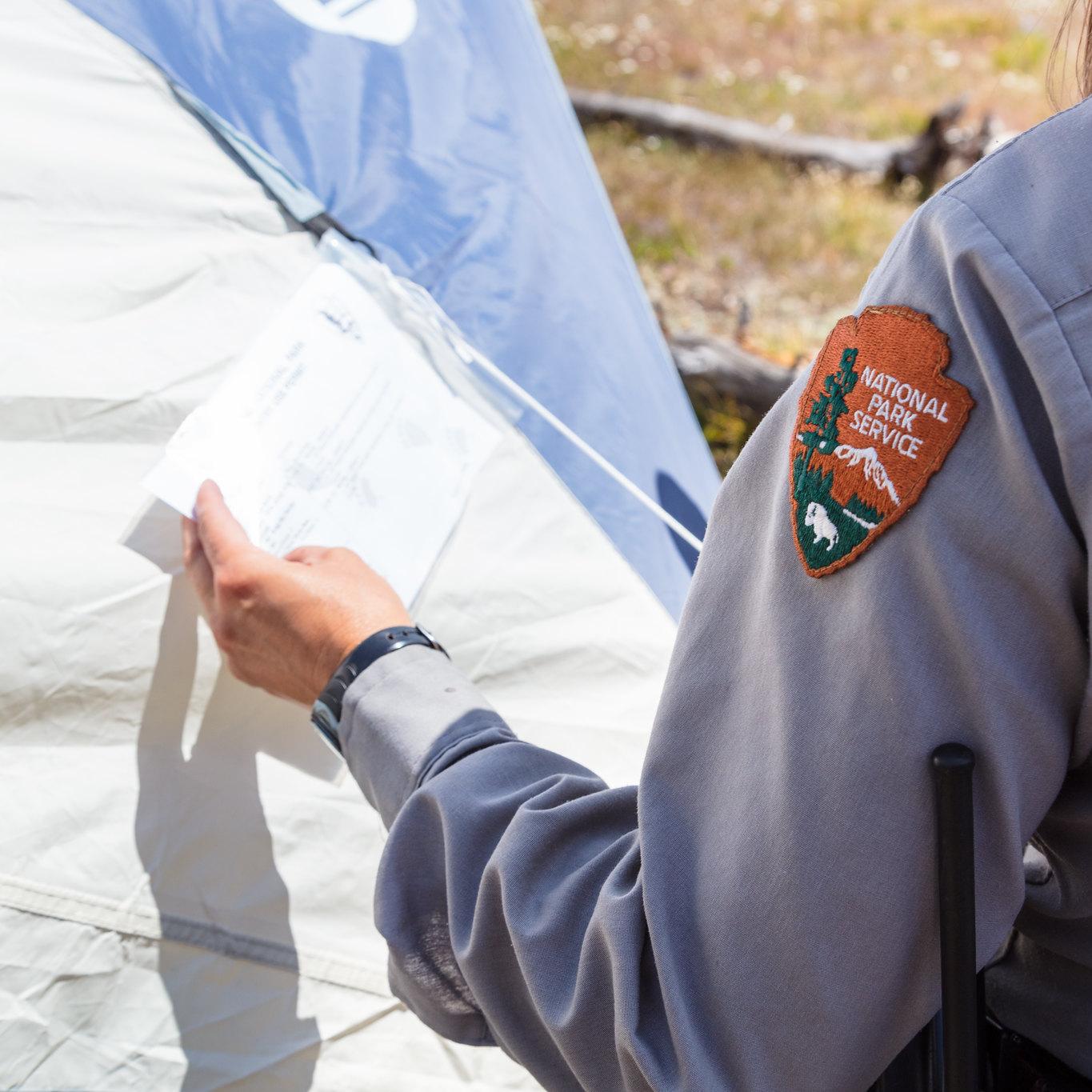 Park ranger inspects a permit
