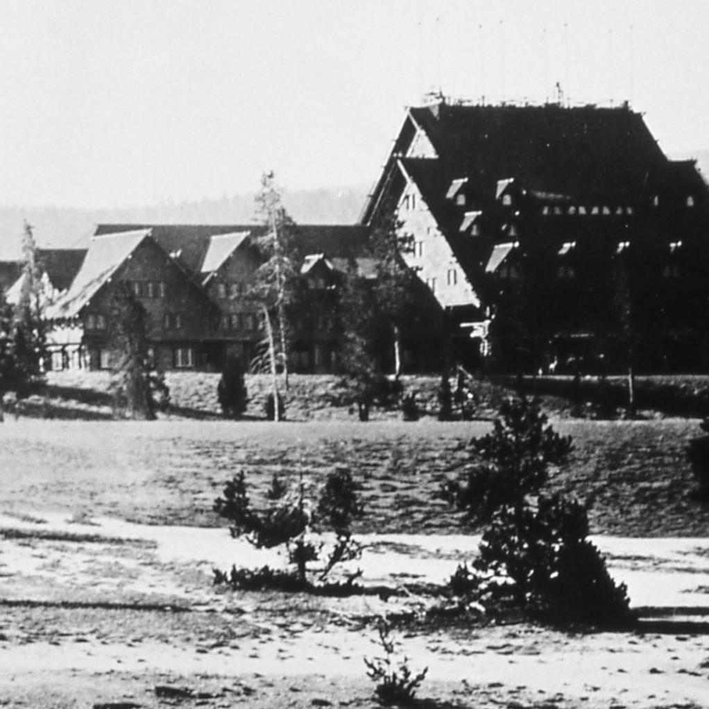 Black and white image of a large, wooden A-frame structure.