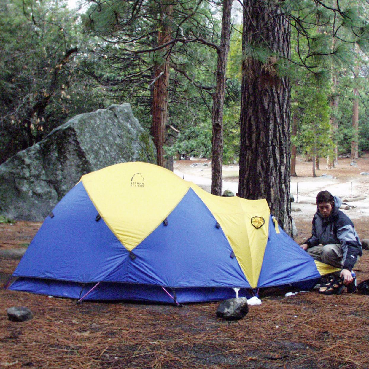 Tent being staked down by campers
