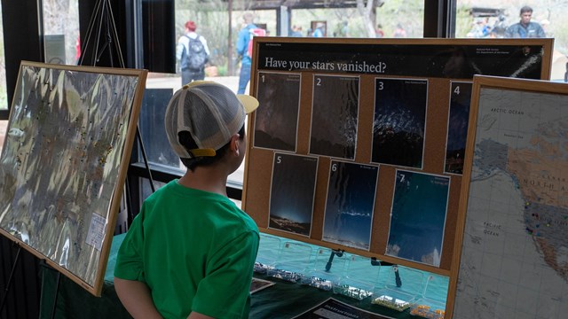 A child looking at a dark sky display