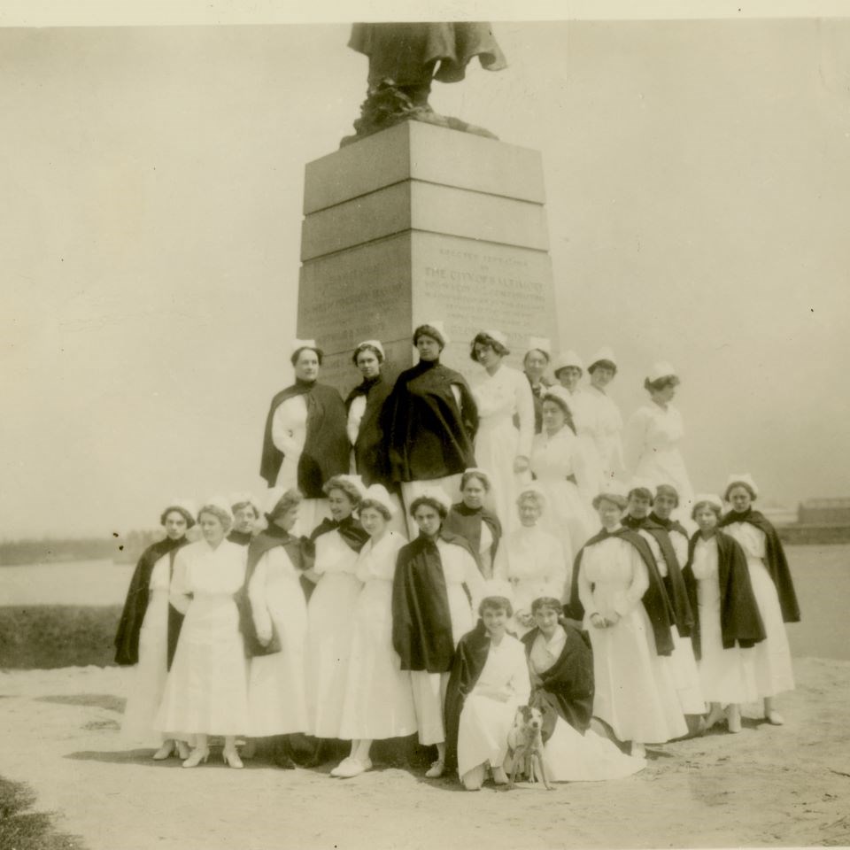 Nurses pose with the statue of Armistead, which once stood on a bastion looking out onto the Patapsco River.