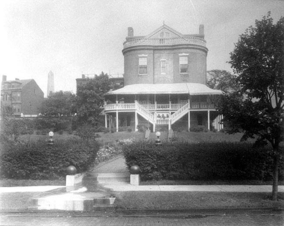 Black and white photo of Commandant's House with covered porch.