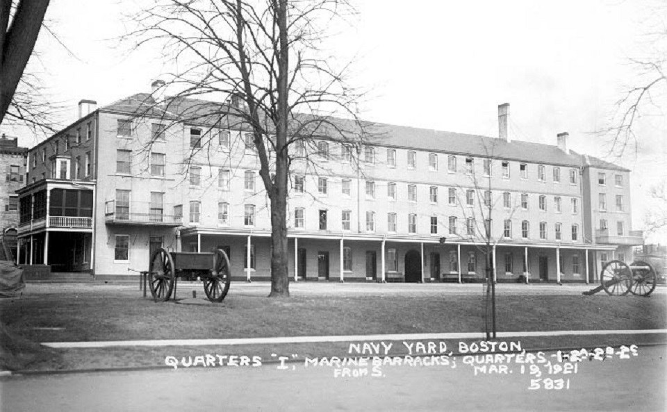 Black and White photograph of the Marine Barracks with a covered porch on the first floor.