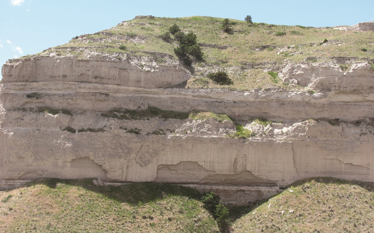 Photo of a cliff with bands of layered rock.