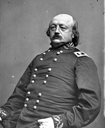 B&amp;W photo of butler seated in Civil War Uniform.  He is bald with dark hair and a mustache.