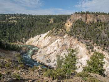 View from the top of a cliff where the Yellowstone River cuts a deep canyon.