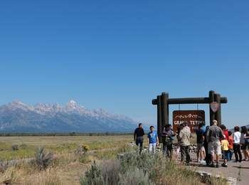 Group of visitors at the South Boundary Turnout with the sagebrush flats and Teton Range beyone