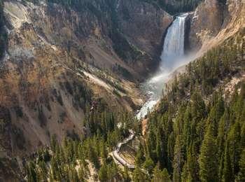 A view from above a boardwalk looking onto a waterfall