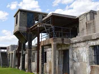 The multi-storied grey cement Nine Gun Battery is crisscrossed with metal staircases.