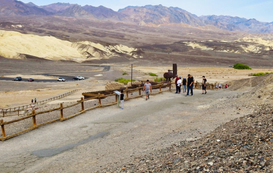 Cylindrical tanks with building and desert mountains.