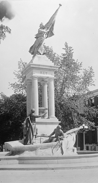Stone monument with Liberty atop with flag with the name Key carved in the stone