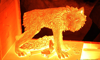 Wolf sculpture glows in firing kiln
