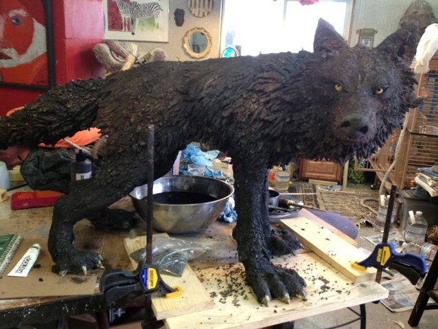 Finished wolf sculpture on work bench.