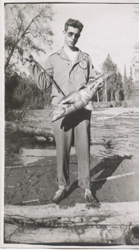 A man holds a fish for the camera