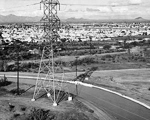 Black and white photo of a large town at a far distance next to Crosscut Canal