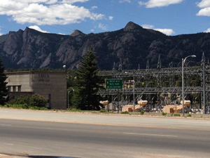 Photo of Estes Powerplant surrounded by mountains and blue sky