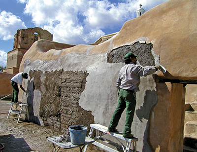 Cultural resource specialists maintain an adobe structure at Tumacacori National Historical Park