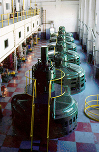 Photo of several large green electric units lining in a row 
