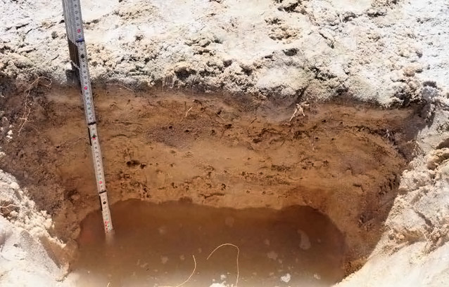 Water filling the bottom of a shallow hole