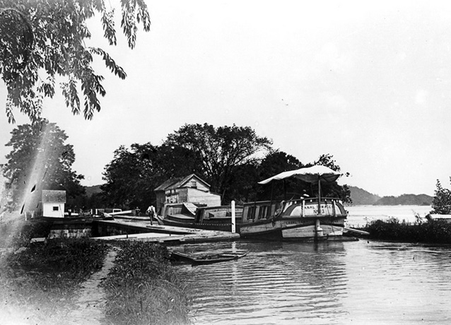 Historic photo of a person on a dock along the waterfront