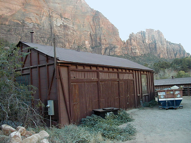 Steep cliffs beyond a rectangular brown garage