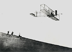 Photograph of Orville Wright in his glider at Kitty Hawk, North Carolina, in 1911.