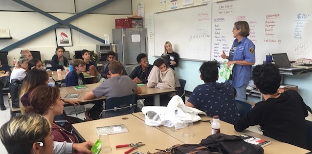 Cabrillo Volunteer talking with students about Native Plants