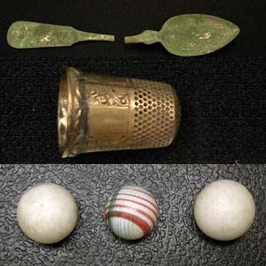 Domestic artifacts like spoons, thimbles, and marbles.