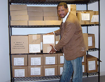 An employee disseminates a shipment of work supplies and equipment.