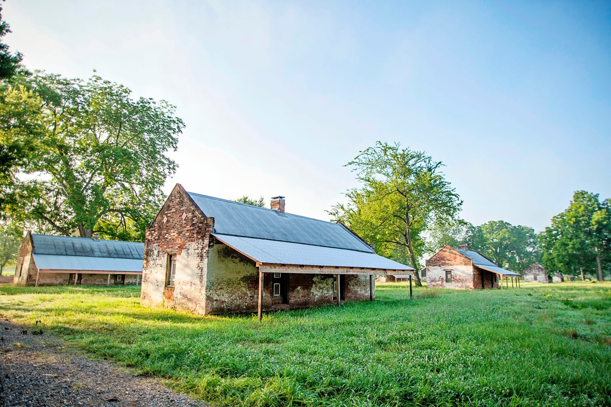 Brick cabins built to house enslaved workers, served as homes for tenant farmers into the 1960s.