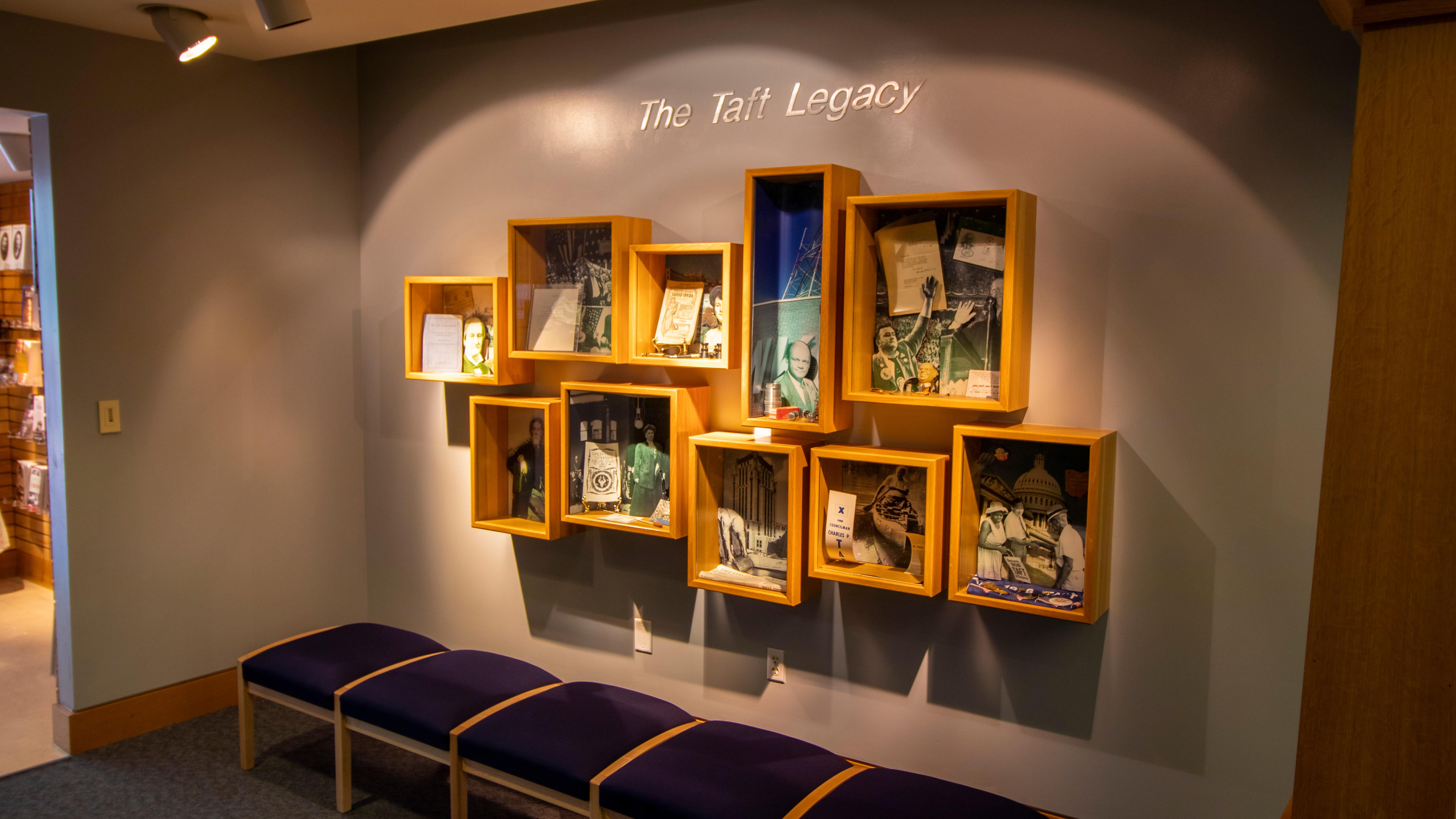 Several small and medium-sized glass-covered boxes with different displays inside of them on a wall