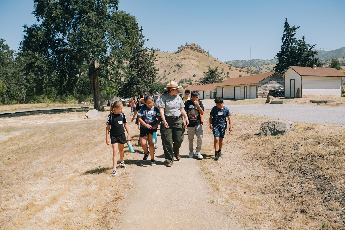 A ranger leads a group of students down a path on the grounds of the Cesar Chavez National Monument.