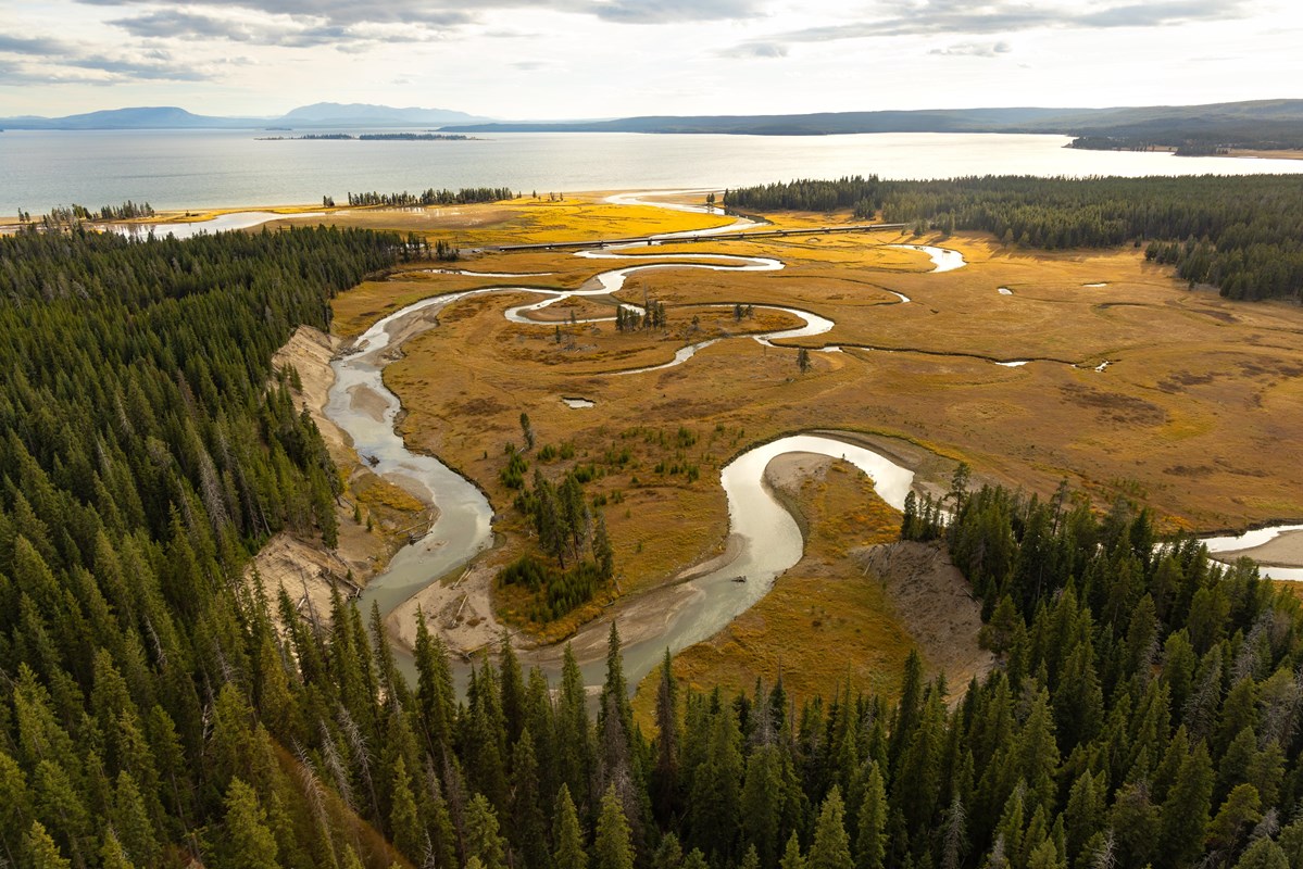 A creek winds towards a large lake