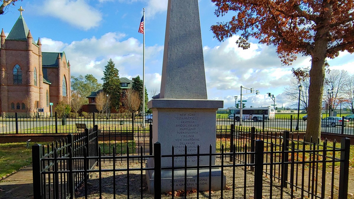 A granite obelisk, about 15" tall, has the original 13 states' names and the Oneidas etched on it.