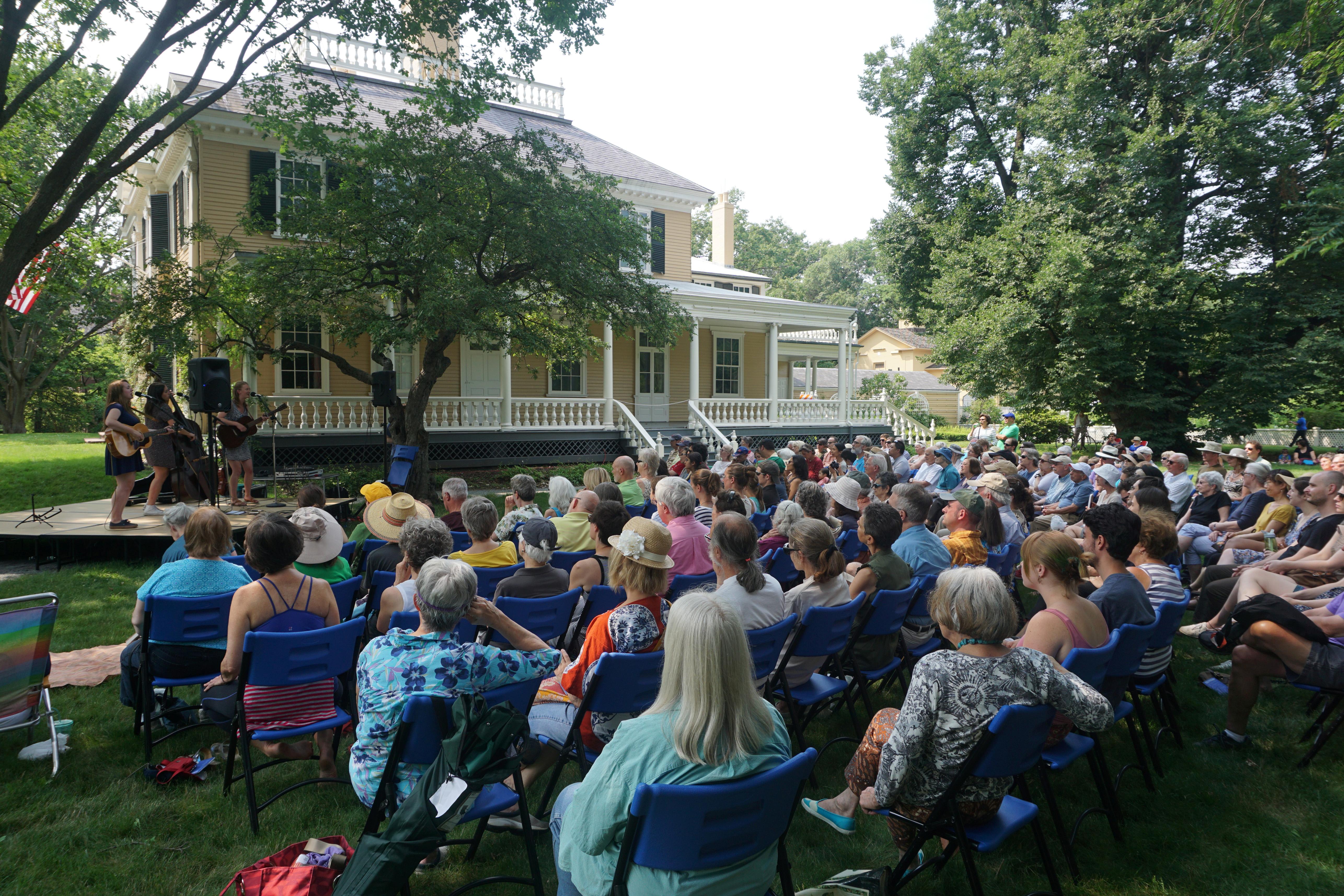 large crowd on the east lawn listening to singers perfom