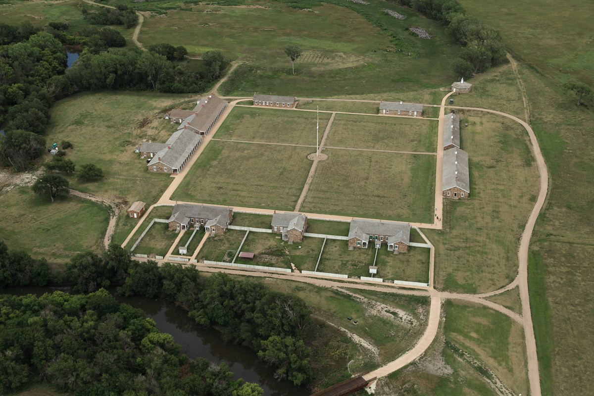 Sandstone army buildings arranged in a square around parade ground.
