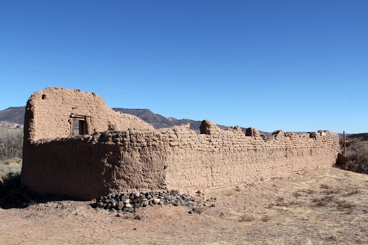 crumbling adobe structure with blue sky 