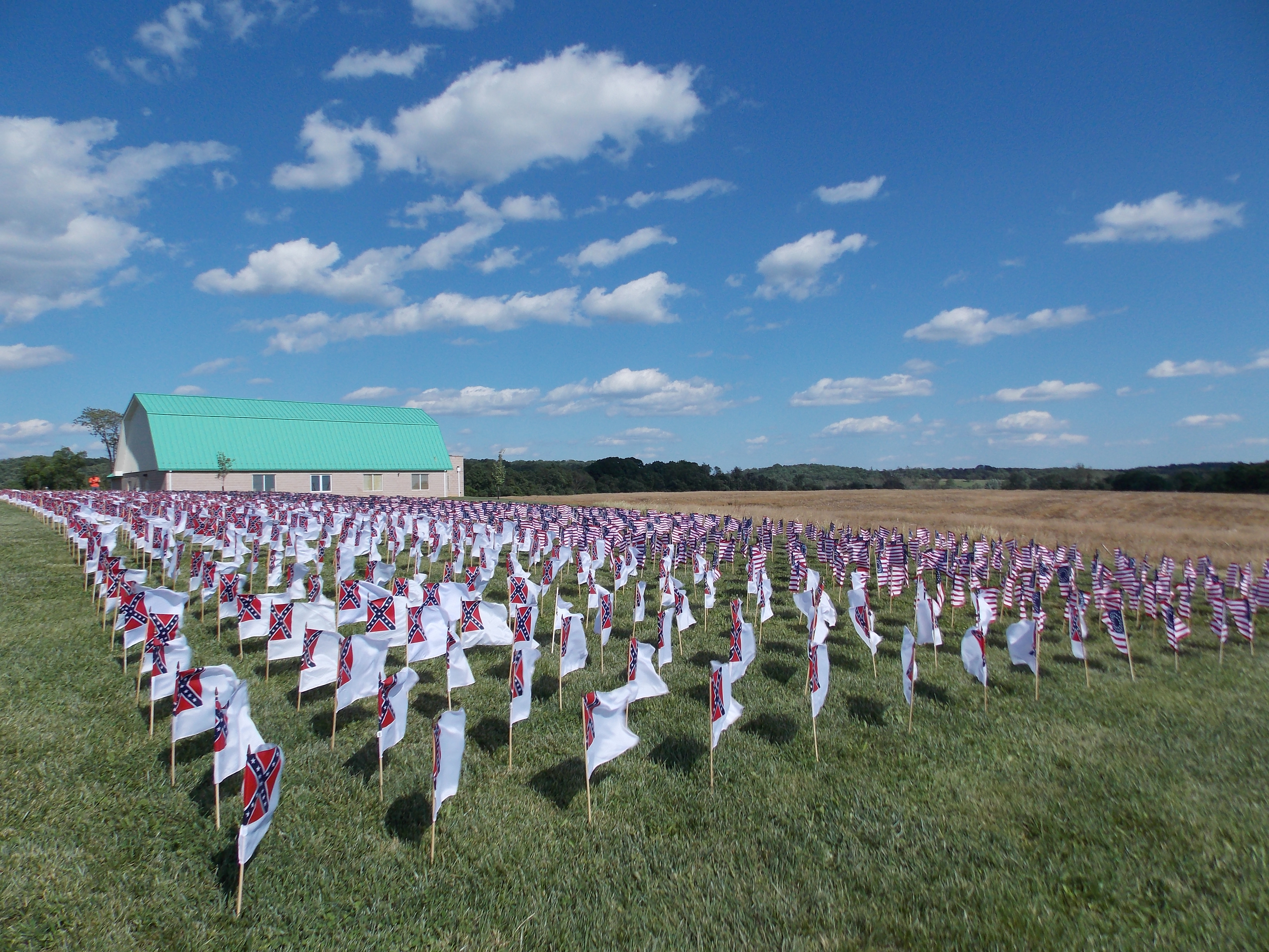 Small flags fly in the breeze in front of the visitor center.