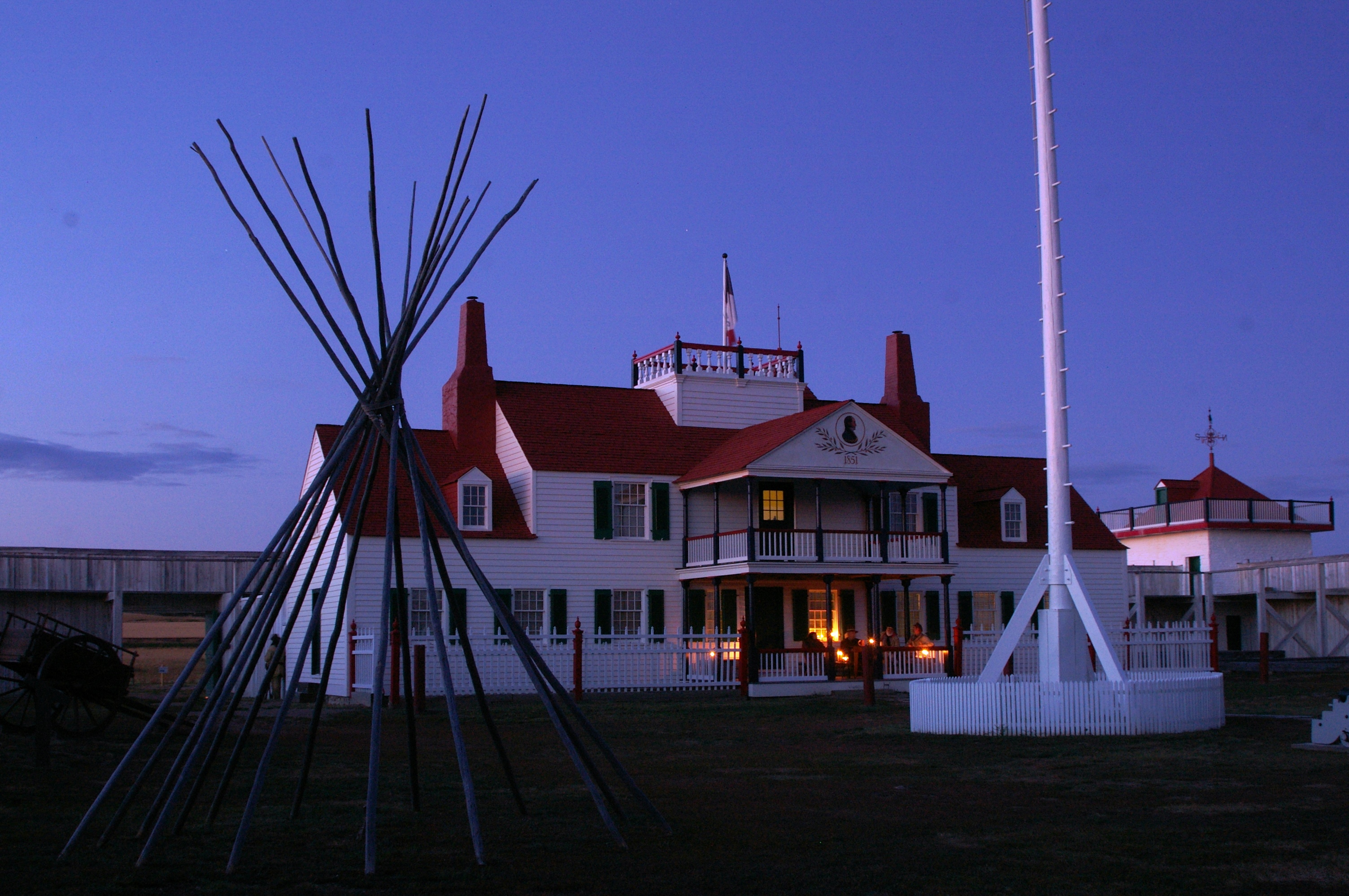 Candles illuminate the Bourgeois House porch at dusk