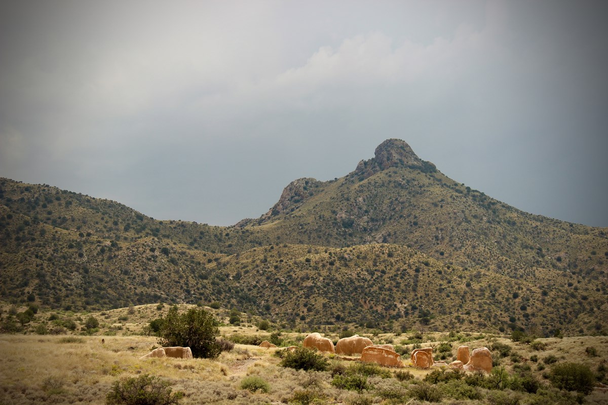 Ruined walls of the old buildings and mountains in the background
