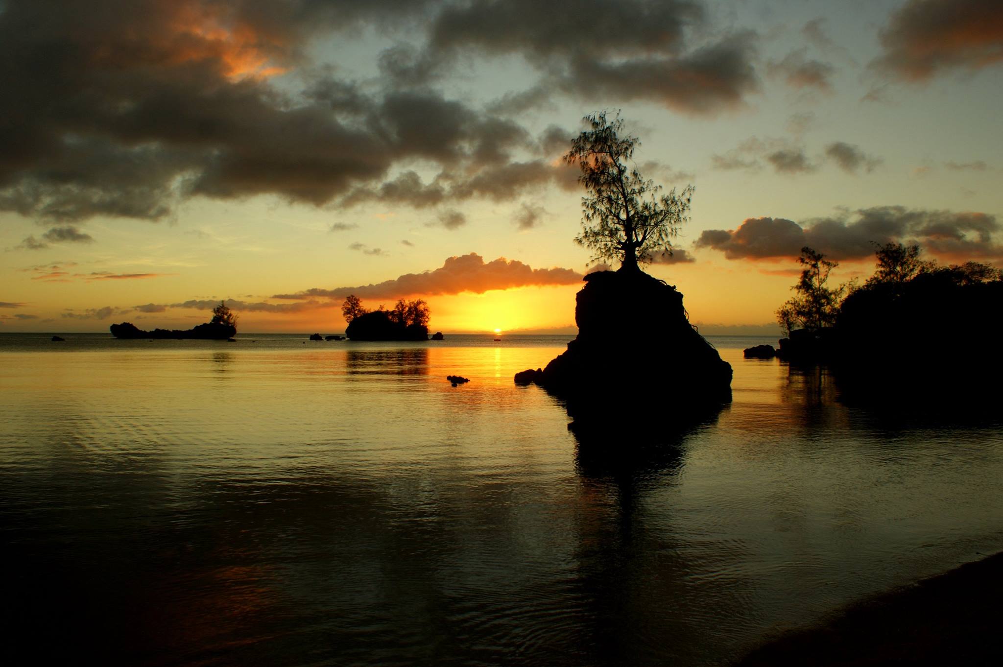 Calm water beach at sunset.