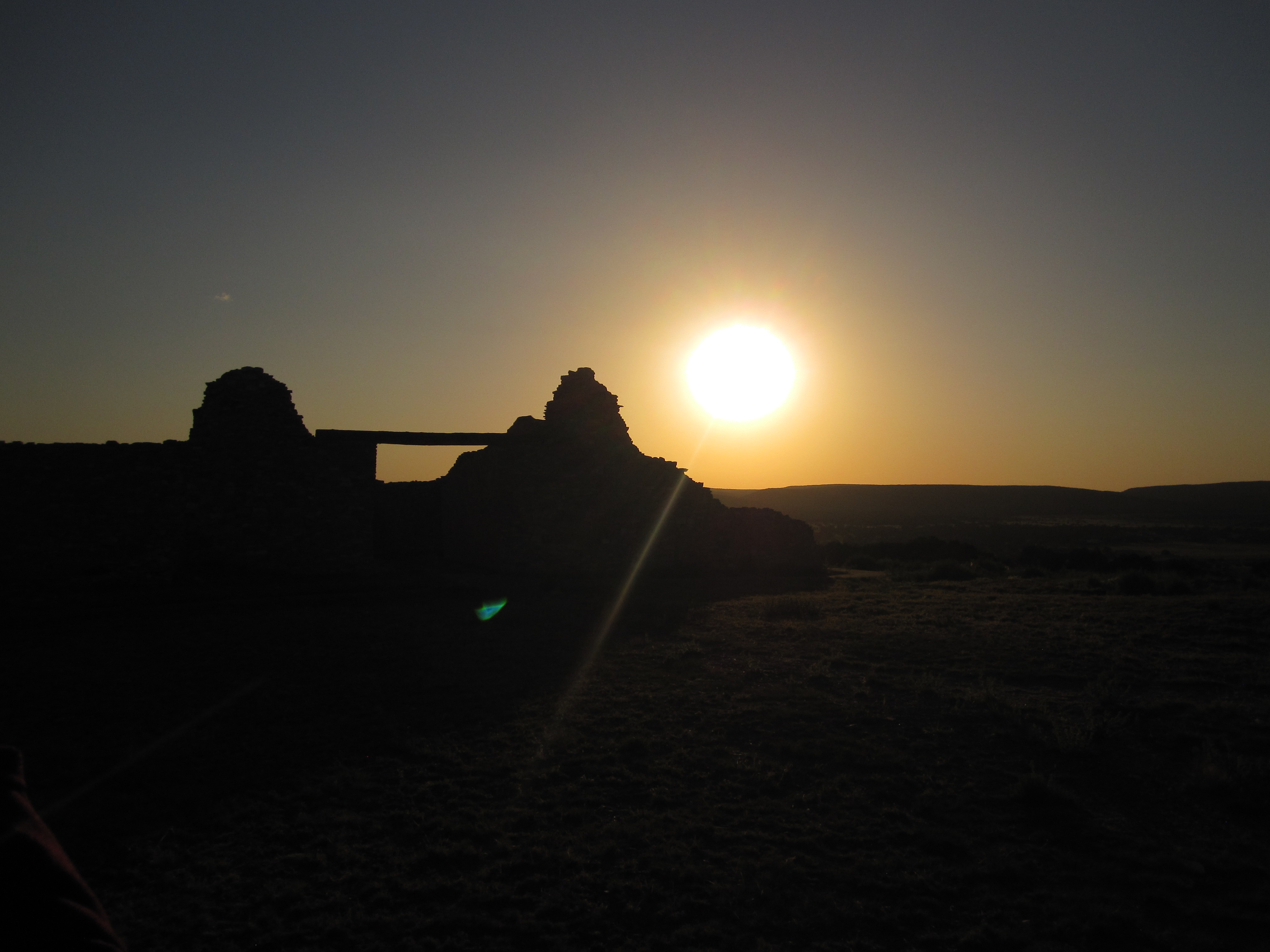 An solar eclipse outlines an old stone structure at Salinas Pueblo Missions.