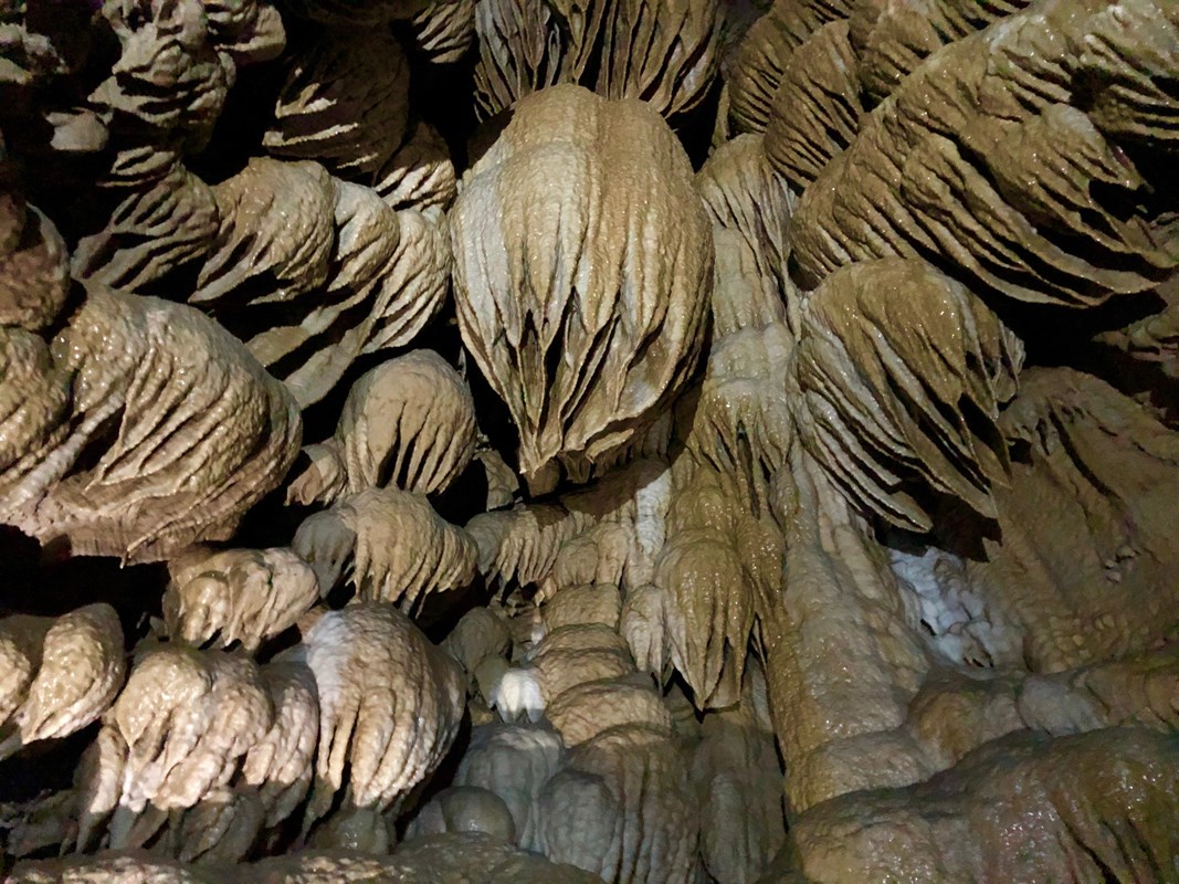 Flowstone and drapery in a dome pit 