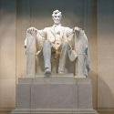 Marble statue of a man sitting on a chair