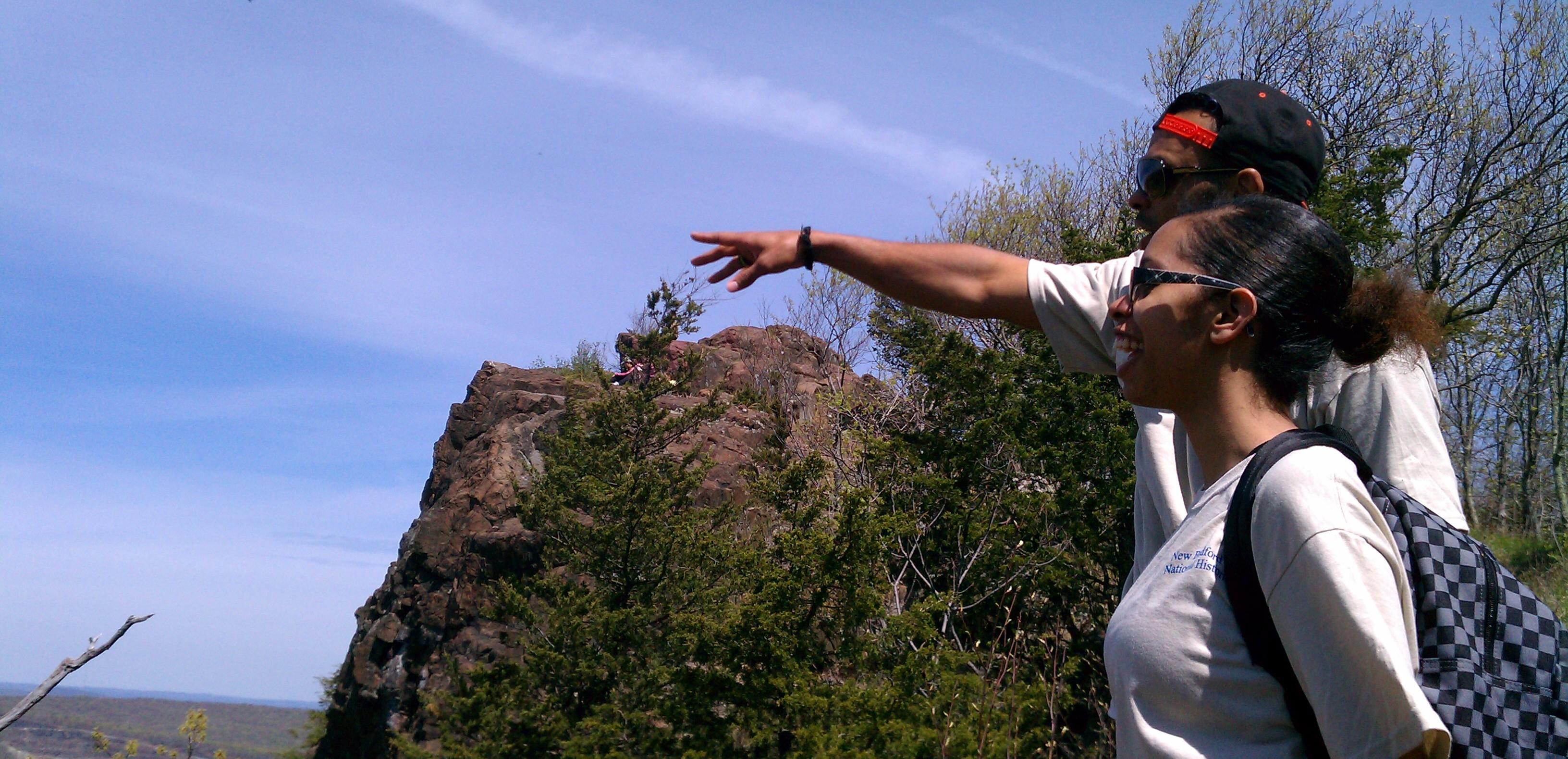 Two youth pointing out over the trail from the top of Mt Higby