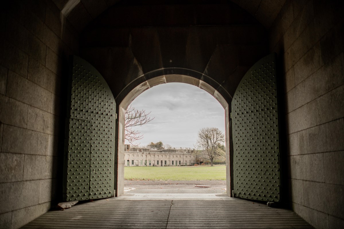 A big arched door opens to the parade ground of Fort Warren.