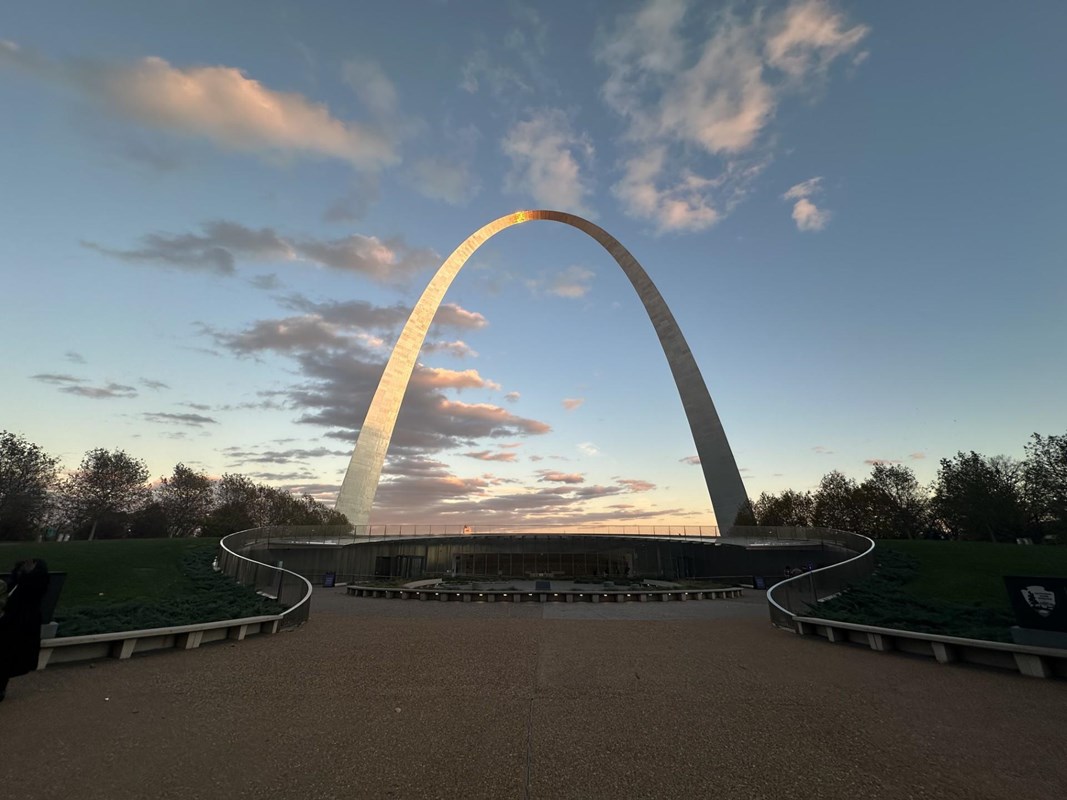 The Gateway Arch against clouds in a blue sky