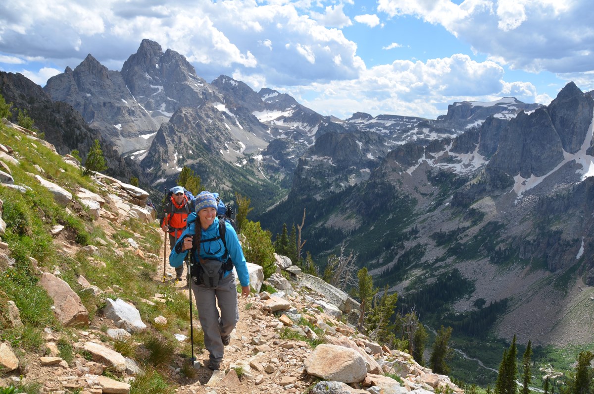 Two backpackers hiking through the mountains